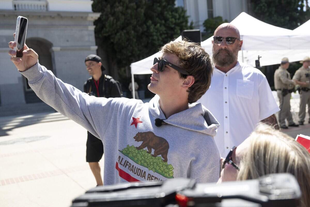 Influencer Nick Shirley takes selfies with fans during a rally in opposition to Assembly Bill 2624, also known as the “Stop Nick Shirley Act," at the California Capitol in Sacramento on Wednesday, Aug. 26, 2026. The bill extends an address confidentiality program to immigration service providers.