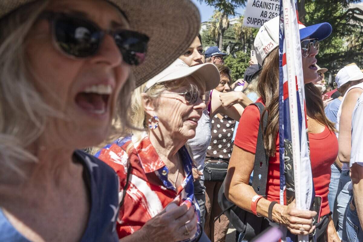 Fans of influencer Nick Shirley cheer during a news conference in opposition to Assembly Bill 2624, also known as "the Stop Nick Shirley Act," at the California Capitol in Sacramento on Wednesday, Aug. 26, 2026. The recently signed bill extends an address confidentiality program to immigration service providers.