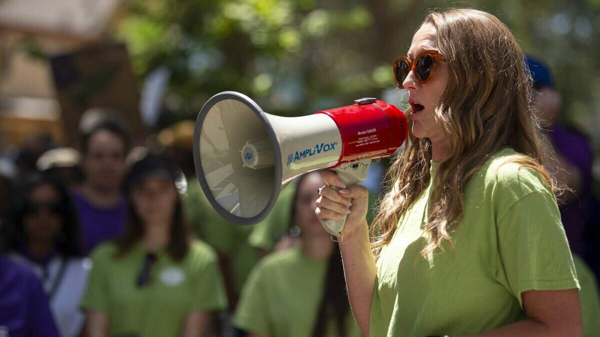 Jacqueline Tkac, president of the California Association Professional Scientists UAW Local 1115, speaks at a rally outside the California Department of Human Resources in Sacramento on Wednesday, Aug. 5. Union members rallied in support of salary increases and against Governor Gavin Newsom’s return-to-office mandate.