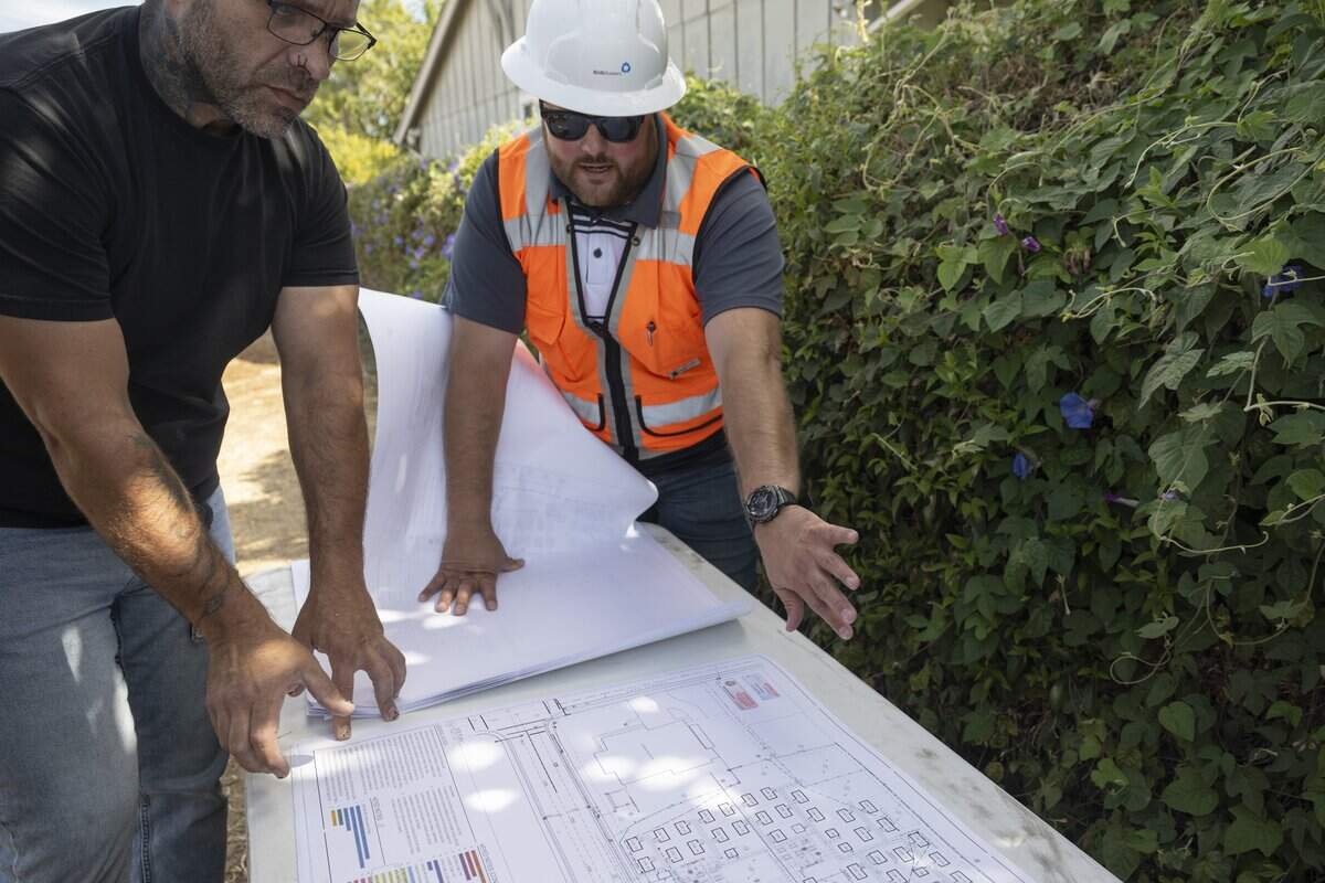 G&G Builders Superintendent Keith Lucas and Sacramento Building Inspector Sotirios Mathiopolos go over building plans for the future Gardendale Road micro-community for homeless Sacramento seniors on Thursday. Thirty tiny homes are planned for the site.