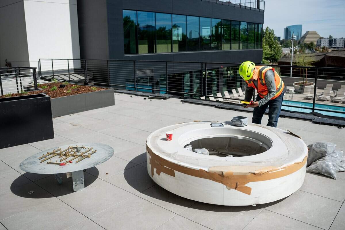 A construction worker works on the fire pit construction at Pierside in West Sacramento’s Bridge District on Thursday, Aug. 20, 2026.