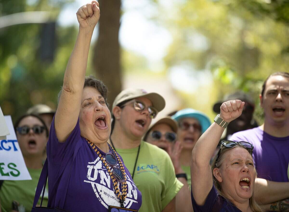 Members of SEIU Local 1000 chant in support of CAPS-UAW outside the California Department of Human Resources in Sacramento on Wednesday. CAPS union members rallied in support of salary increases and against Gov. Gavin Newsom’s return-to-office mandate.