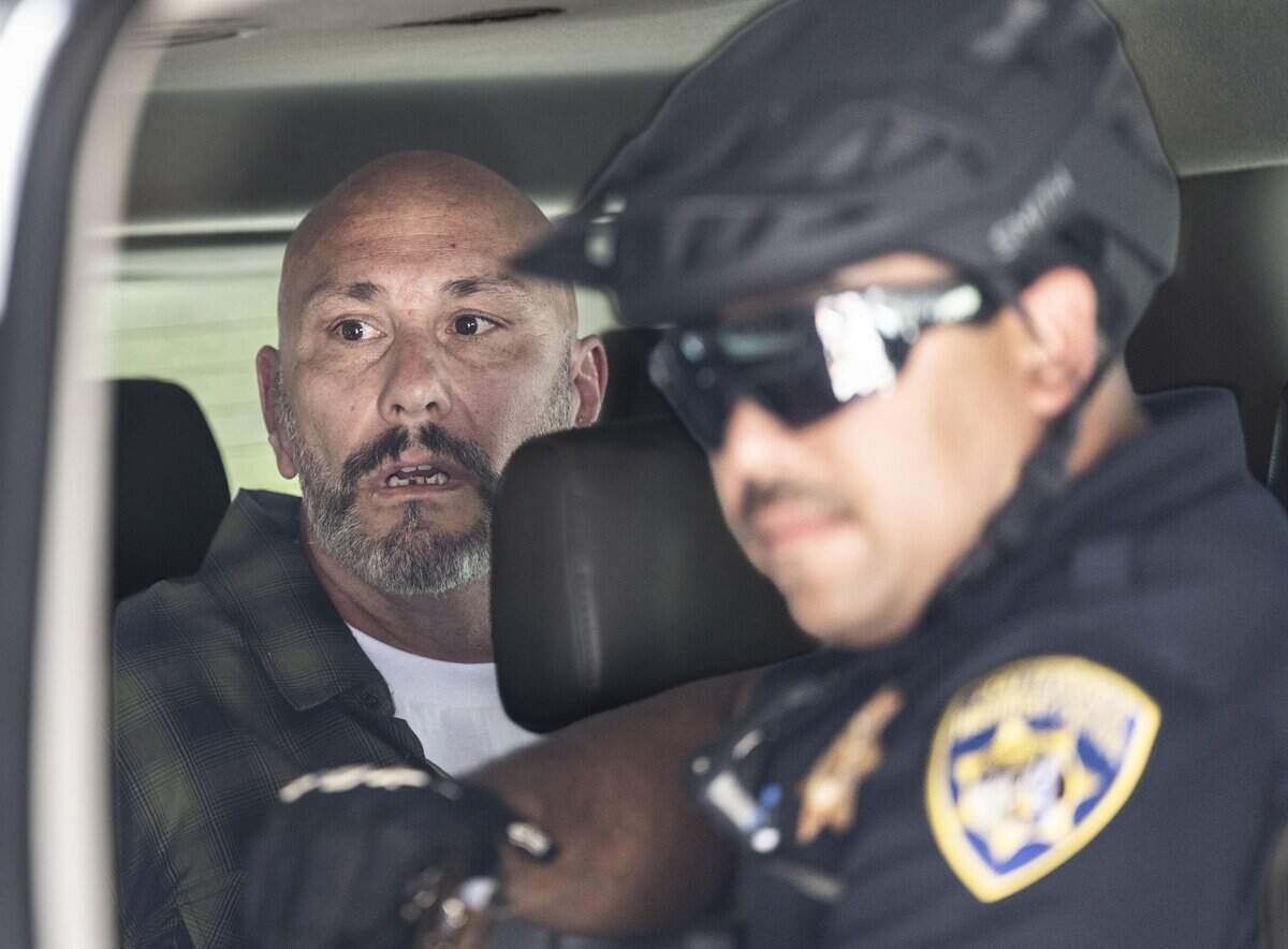 A man who was involved in a scuffle over a flag is detained by the California Highway Patrol during Nick Shirley's appearance at a Republican news conference at the state Capitol on Wednesday, Aug. 26, 2026.