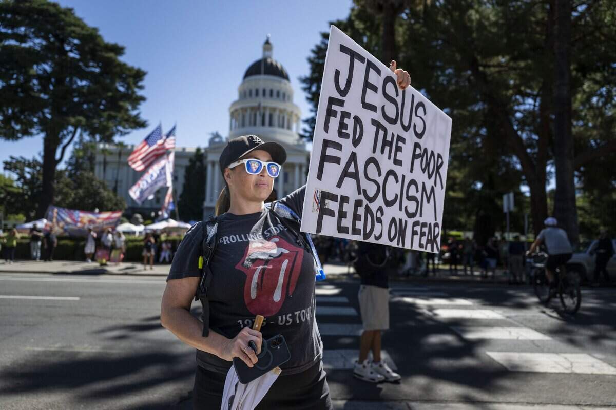 Olivia Park, of Sacramento, joins a goup of protesters to demonstrate against online political influencer Nick Shirley's appearance at a Republican news conference at the state Capitol on Wednesday, Aug. 26, 2026.