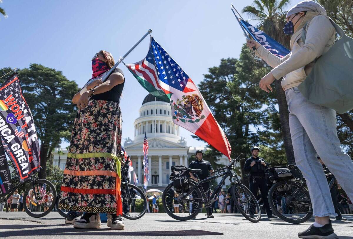 A group gathers near the state Capitol to demonstrate against online political influencer Nick Shirley's appearance at a Republican news conference on Wednesday, Aug. 26, 2026.