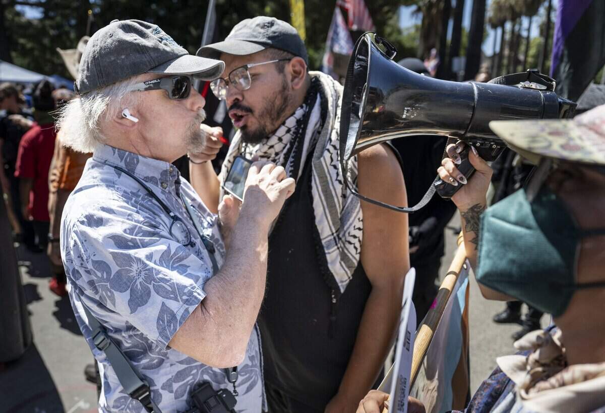 A man is confronted as supporters and protesters face off during online political influencer Nick Shirley's appearance at a Republican news conference at the state Capitol on Wednesday, Aug. 26, 2026.