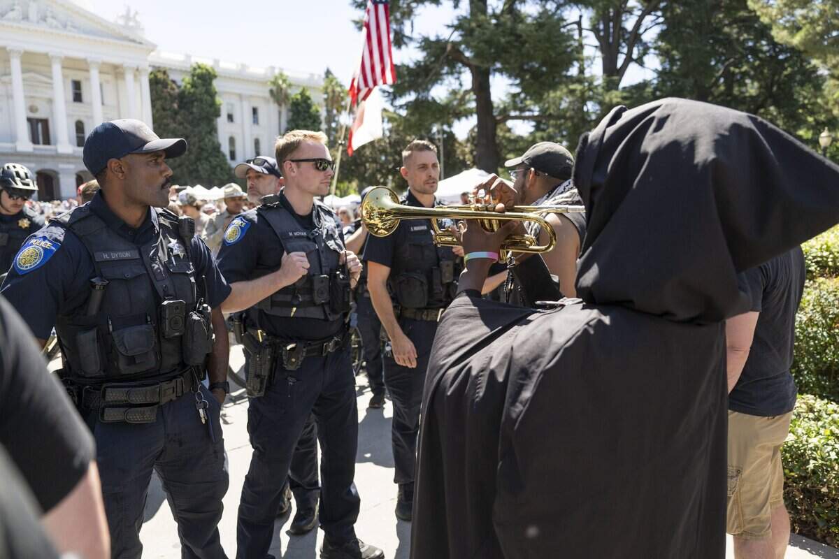 Sacramento police officers hold a line near the west steps of the state Capitol during a rally featuring conservative influencer Nick Shirley on Wednesday, Aug. 26, 2026.