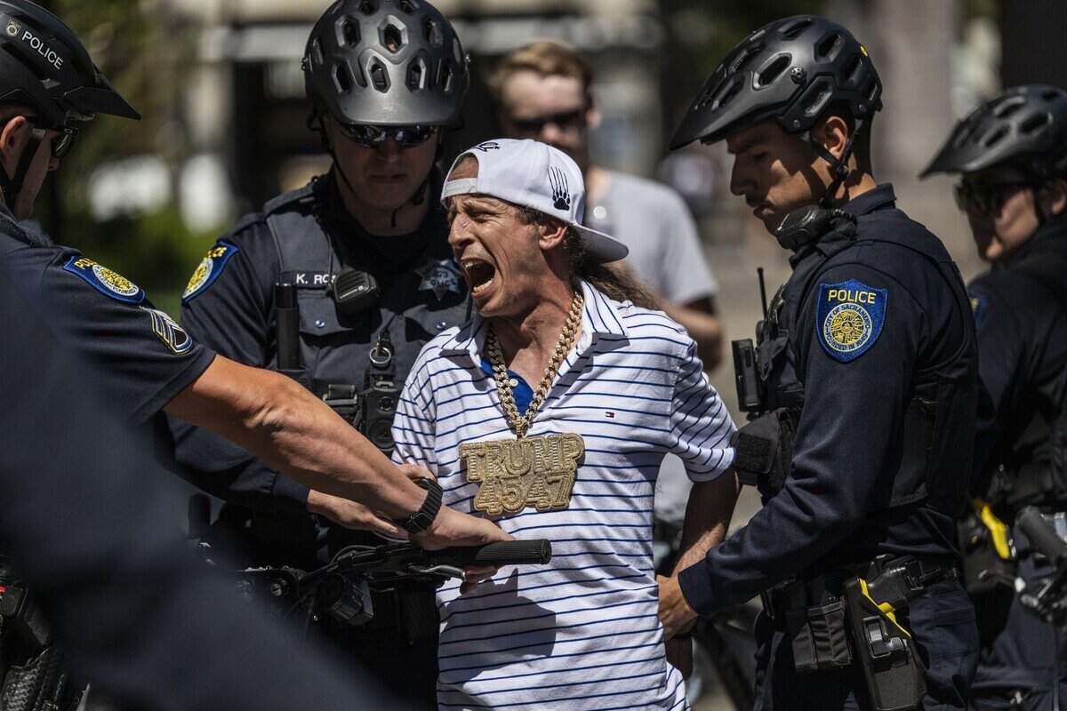 A man is arrested by Sacramento police officers after he allegedly pepper-sprayed people protesting against conservative influencer Nick Shirley’s appearance at the state Capitol on Wednesday, Aug. 26, 2026.