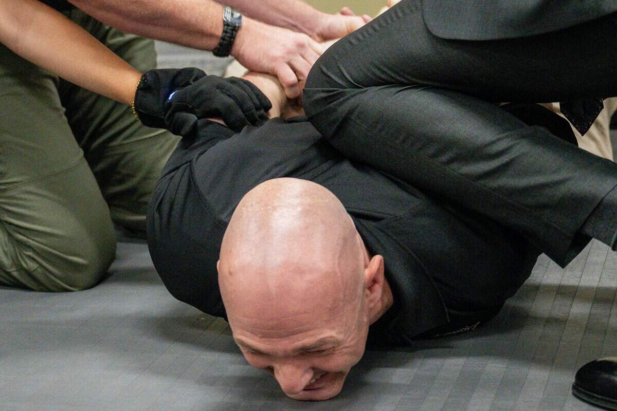 Lt. Will Vernon participates in an electric glove demo session during a news conference at the Sacramento County Sheriff's Office Headquarters on Thursday.