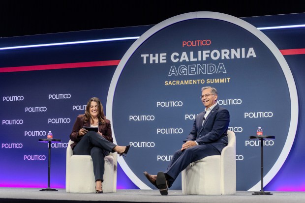 Politico California Bureau Chief Melanie Mason, left, and California Democratic gubernatorial candidate Xavier Becerra, right, during a summit hosted by Politico on Tuesday, Aug. 11, 2026, in Sacramento, Calif. (AP Photo/Annie Barker)