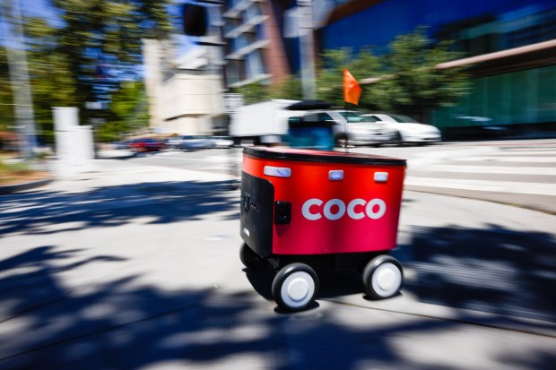 A Coco delivery robot travels along the sidewalk in downtown San Jose, Calif., on Thursday, July 30, 2026. (Shae Hammond/Bay Area News Group)