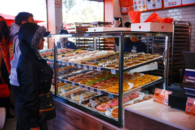 People buy donuts during Randy's Donuts' grand opening in Santa Clara, Calif., on Friday, July 31, 2026. (Shae Hammond/Bay Area News Group)