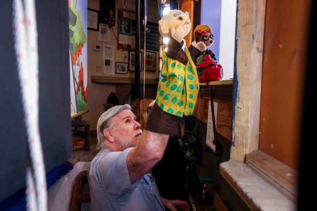 Children's Fairyland puppet theater director Randal Metz works on a live puppet show backstage in Oakland, Calif., Thursday, June 27, 2026. Metz, who said he started at age 10, has been a puppeteer for 57 years. (Ray Chavez/Bay Area News Group)