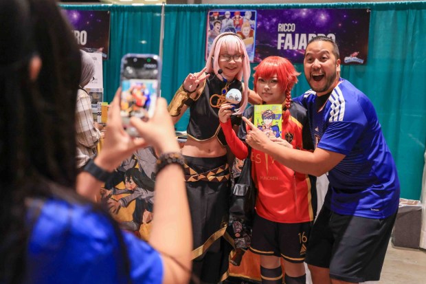 Voice actor Ricco Fajardo, of San Jose, right, poses for photos with Sunnyvale fans Chloe Hoge, left, and Kyo Rodriguez during GalaxyCon San Jose at the San Jose McEnery Convention Center in San Jose, Calif., on Friday, Aug. 28, 2026. (Ray Chavez/Bay Area News Group)