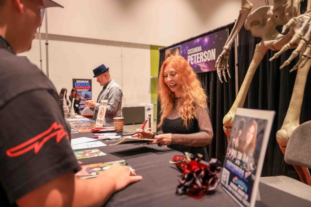 Actress Cassandra Peterson talks with a fan as she signs autographs during GalaxyCon San Jose at the San Jose McEnery Convention Center in San Jose, Calif., on Friday, Aug. 28, 2026. (Ray Chavez/Bay Area News Group)