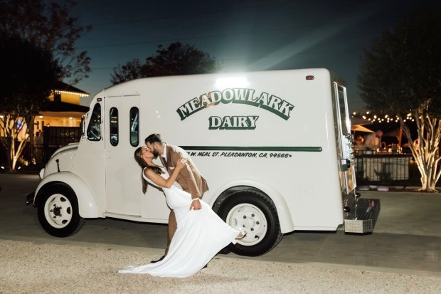Meadowlark Dairy, which has locations in Pleasanton and Livermore, restored a vintage ice-cream truck that it rents out for special events. A couple celebrates their marriage posing with the Meadowlark truck. (Courtesy of Meadowlark Dairy)