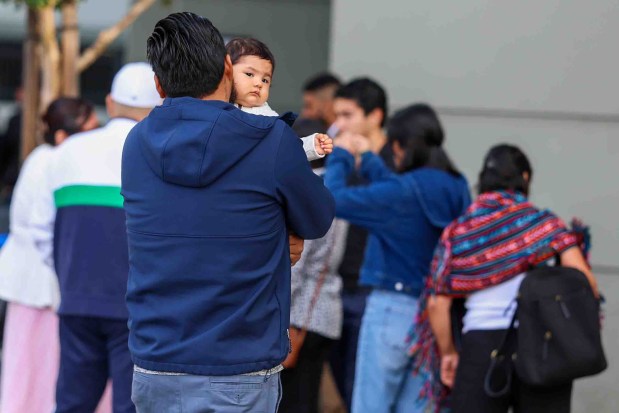 Migrants wait in line for an immigration hearing at the immigration court in Concord, Calif., on Wednesday, Aug. 12, 2026. The Concord immigration court is holding mass hearings for immigrants facing deportation or seeking asylum. (Ray Chavez/Bay Area News Group)