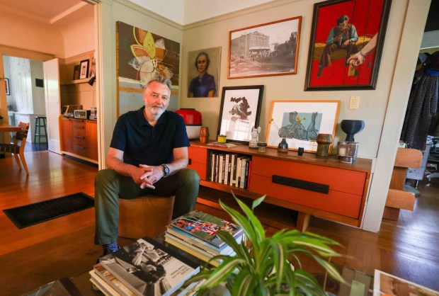 Furniture designer Jason Lees, founder of the regional artisan collective Bay Area Made, sits in the living room which features a custome made walnut wood console he made in Oakland, Calif., on Saturday, June 20, 2026. Lee's home includies  a walnut dining table, and a mixed walnut and birch wood stereo cabinet. (Ray Chavez/Bay Area News Group