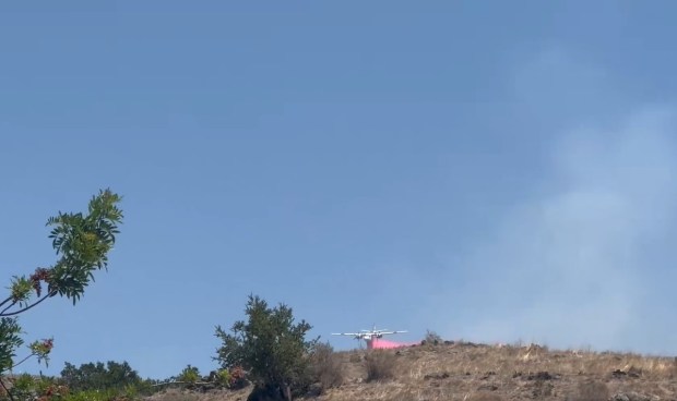 A plane spreads fire retardant on a fire in the Coyote Valley area of South San Jose, as seen on Aug. 8, 2026.(Cal FIRE)