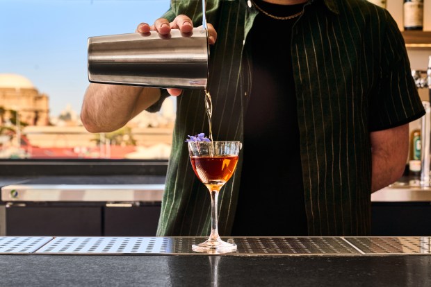 A bartender pours a cocktail at San Francisco's the Mess Hall at the Presidio, which includes a full bar. (Courtesy of Erin Ng)