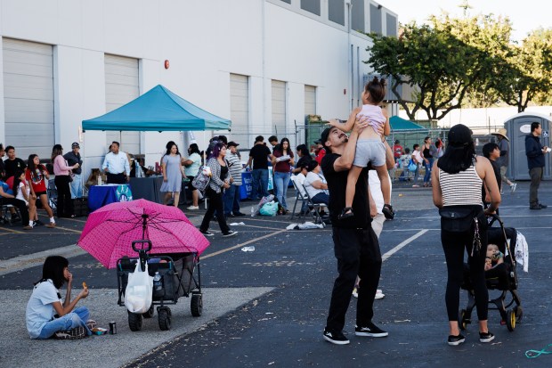 Aaron Yamamoto of San Jose lifts up his daughter, Rini, 4, during a National Night Out event in San Jose, Calif., on Aug. 4, 2026. The community event hosted by nonprofits ConXión to Community and Martha's Kitchen featured a free backpack giveaway, a petting zoo, face painting, free food, live music and others. (Dai Sugano/Bay Area News Group)