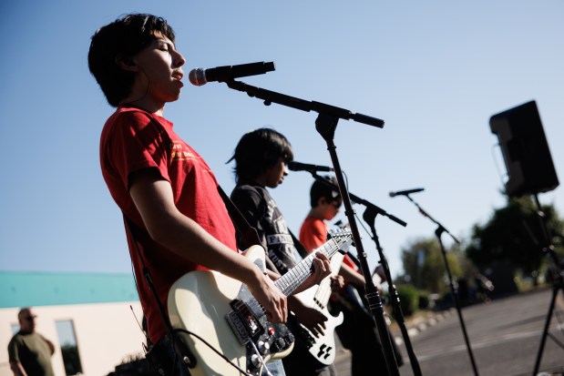Yerba Buena High School student Germain Renteria, 17, a guitarist for the band, "Viktor and Friends," performs rock music with his bandmates during a National Night Out event in San Jose, Calif., on Aug. 4, 2026. The community event hosted by nonprofits ConXión to Community and Martha's Kitchen featured a free backpack giveaway, a petting zoo, face painting, free food, live music and others. (Dai Sugano/Bay Area News Group)
