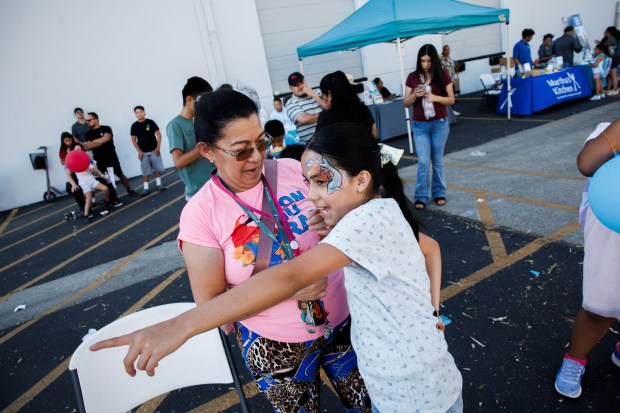 Genesis Funes, 10, points out a petting zoo to her mother, Rosa Perlera, during a National Night Out event in San Jose, Calif., on Aug. 4, 2026. The community event hosted by nonprofits ConXión to Community and Martha's Kitchen featured a free backpack giveaway, a petting zoo, face painting, free food, live music and others. (Dai Sugano/Bay Area News Group)