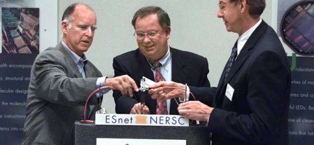 Oakland Mayor Jerry Brown (left), Berkeley Lab Director Chuck Shank (center), and James Decker of the U.S. Energy Department Science Office (right) officially connect the Lawrence Berkeley National Laboratory supercomputing and data storage complex at 415 20th Street in downtown Oakland to the federal Energy Sciences Network, as seen in 2001 (Lawrence Berkeley National Laboratory)