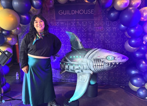 Artist Cindy Duong stands next to "Fishbones," an art shark she painted, during Guildhouse's fifth anniversary celebration in downtown San Jose on Thursday, July 30, 2026. (Sal Pizarro/Bay Area News Group)