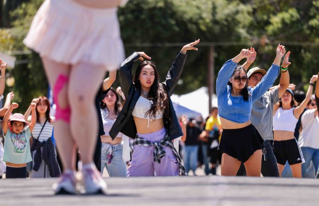 Festivalgoers follow the dance moves of Katherine Gao and Jessalyn Ocampo, of San Francisco's K-Pop-Up Dance, during the SJMADE Fest at History Park in San Jose, Calif., Saturday, May 30, 2026. (Ray Chavez/Bay Area News Group)