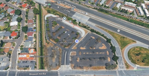 Surface parking lot at 605 Blossom Hill Road in south San Jose. The interchange of State Route 85 and Blossom Hill Road is visible to the right. The Blossom Hill light rail station is visible in the upper section of the image. (Google Maps)