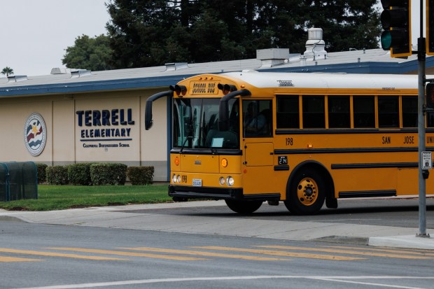 After picking up Gio Naughton, 7, and other students, a school bus leaves the closed Terrell Elementary School on Aug. 7, 2026, in San Jose, Calif. Terrell Elementary School closed along with four other campuses earlier this year. Naughton now attends Rachel Carson Elementary. (Dai Sugano/Bay Area News Group)