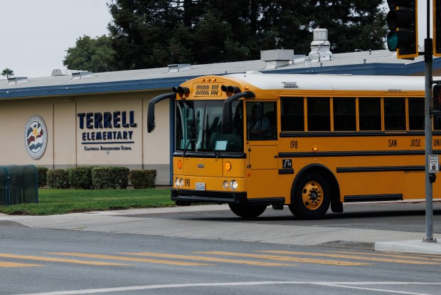 After picking up Gio Naughton, 7, and other students, a school bus leaves the closed Terrell Elementary School on Aug. 7, 2026, in San Jose, Calif. Terrell Elementary School closed along with four other campuses earlier this year. Naughton now attends Rachel Carson Elementary. (Dai Sugano/Bay Area News Group)