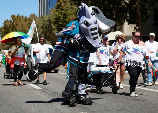 San Jose Sharks mascot S.J. Sharkie gets a ride from San Jose Barracuda mascot Frenzy as they head south on Market Street during the Silicon Valley PRIDE Parade in downtown San Jose, Calif., on Sunday, Aug. 30, 2026. (Nhat V. Meyer/Bay Area News Group)