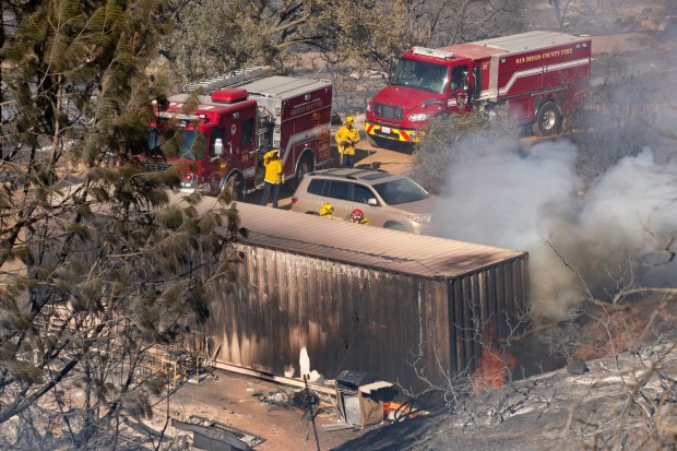 Jamul, CA - The Beaver fire damages nearby property as crews work to gain control on Friday, Aug. 7, 2026, in Jamul, CA. (Luke Johnson / The San Diego Union-Tribune)