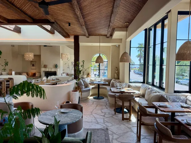 The light-filled By the Sea dining room features natural stone surfaces and flooring. Its inside and outdoor spaces seat more than 200 people. (Douglas Hamm)