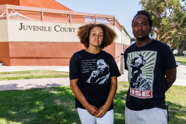 Caitlin Radigan, chair of the county Juvenile Justice Commission, and vice chair Aaron Adkins pose outside outside Juvenile Court in San Diego on July 18, 2026. (Kristian Carreon / The San Diego Union-Tribune)
