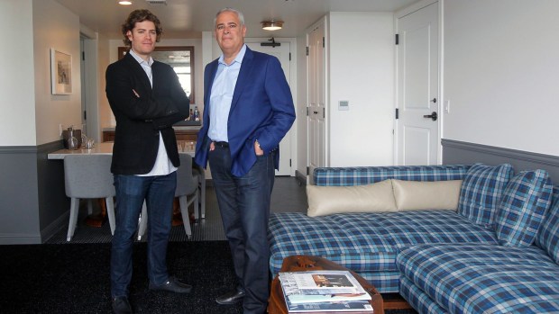 Alan Fuerstman (right), founder of Montage International, and son Michael, who oversees the Pendry Hotels & Resorts brand, stand in one of the Pendry San Diego's suites when it opened in 2017. (K.C. Alfred / The San Diego Union-Tribune)
