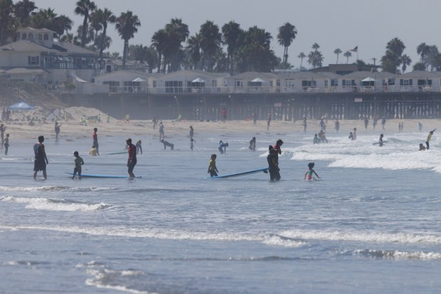 San Diego, California - Beachgoers enjoy the water at Pacific Beach on Thursday, July 30, 2026.(Kristian Carreon / The San Diego Union-Tribune)
