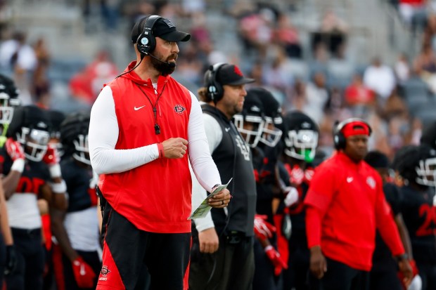 San Diego State coach Sean Lewis watches his players scrimmage at Snapdragon Stadium on Saturday, Aug. 15, 2026 in San Diego, California. (Meg McLaughlin / The San Diego Union-Tribune)