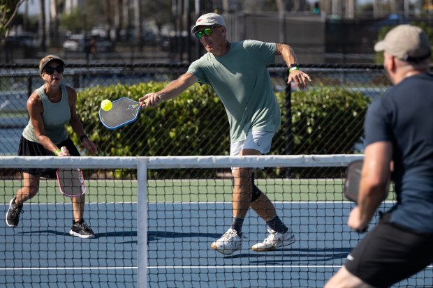 Cheri Turner and Roger Leach play pickleball at the Barnes Tennis Center on Friday, Aug. 28, 2026, in San Diego. (Luke Johnson / The San Diego Union-Tribune)