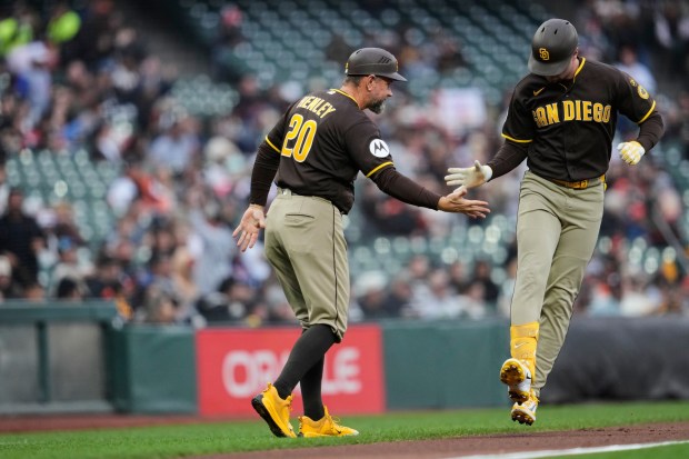 San Diego Padres' Jackson Merrill, right, celebrates with third base coach Bob Henley (20) after hitting a solo home run during the first inning of a baseball game against the San Francisco Giants, Monday, May 4, 2026, in San Francisco. (AP Photo/Godofredo A. VÃ¡squez)