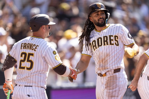San Diego, CA - San Diego Padres outfielder Fernando Tatis Jr., No 23, celebrates with first baseman Ty France, No. 25, after scoring the tying run during a game against the Milwaukee Brewers Wednesday, Aug. 12, 2026, at Petco Park in San Diego, CA. (Luke Johnson / The San Diego Union-Tribune)