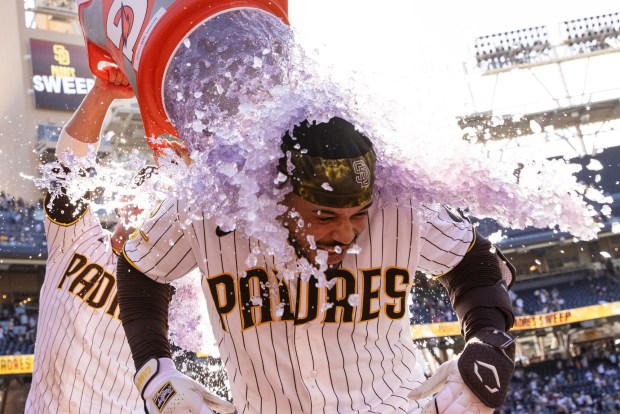 San Diego, CA - San Diego Padres catcher Luis Campusano, No. 12, gets doused in Gatorade by teammate Ty, France, No. 25, as he celebrates after hitting a walk off single during a game against the Milwaukee Brewers Wednesday, Aug. 12, 2026, at Petco Park in San Diego, CA. (Luke Johnson / The San Diego Union-Tribune)