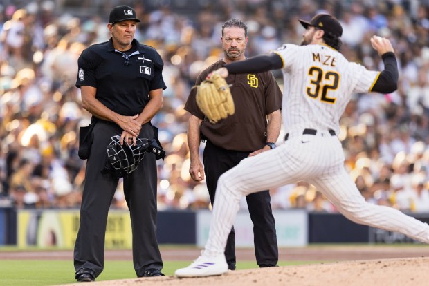 San Diego, CA - San Diego Padres starting pitcher Casey Mize, No. 32, throws a few test pitches before exiting the game against the Minnesota Twins with trainer Mark Rogow Saturday, Aug. 22, 2026, at Petco Park in San Diego, CA. (Luke Johnson / The San Diego Union-Tribune)