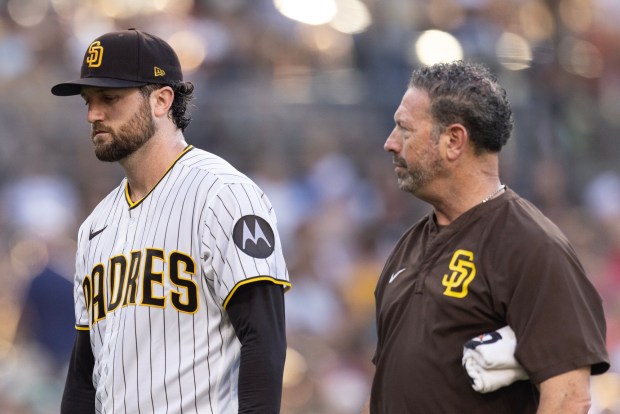 San Diego, CA - San Diego Padres starting pitcher Casey Mize, No. 32, exits a game against the Minnesota Twins with trainer Mark Rogow Saturday, Aug. 22, 2026, at Petco Park in San Diego, CA. (Luke Johnson / The San Diego Union-Tribune)