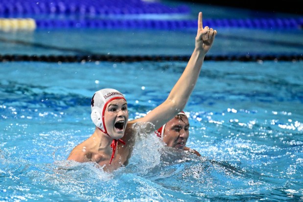 La Jolla High's Dexter Black (left) celebrates after scoring the winning goal against Cathedral Catholic in the CIF San Diego Section Open Division boys water polo championship game Nov. 15 in La Jolla. (Denis Poroy)