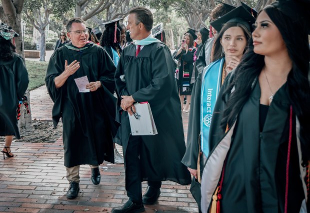 Richard Barrera, the San Diego Unified school board president, speaks with Principal Mitch Booze at the East Village High School graduation ceremony at City College on Friday, June 5, 2026 in downtown San Diego. (Sandy Huffaker for The San Diego Union-Tribune)