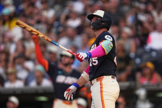 San Diego Padres' Ty France, watches his two-run home run during the first inning of a baseball game against the Minnesota Twins Friday, Aug. 21, 2026, in San Diego. (AP Photo/Gregory Bull)