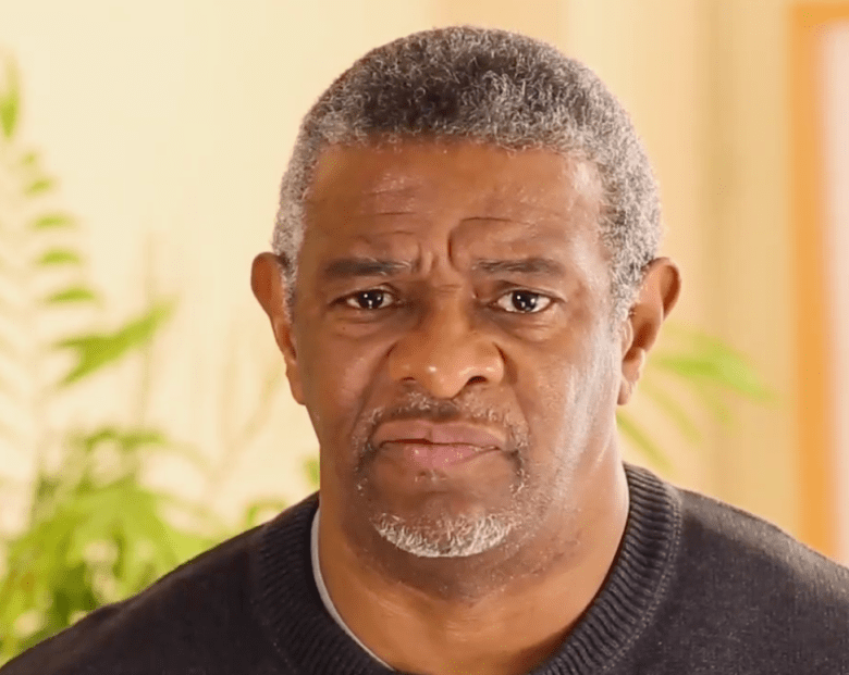 A man looks at the camera.